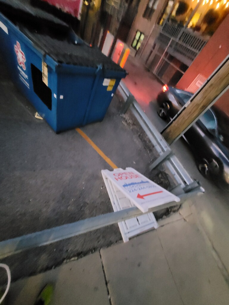 Open House sign blown over